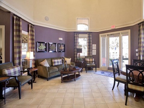a living room with a table and chairs