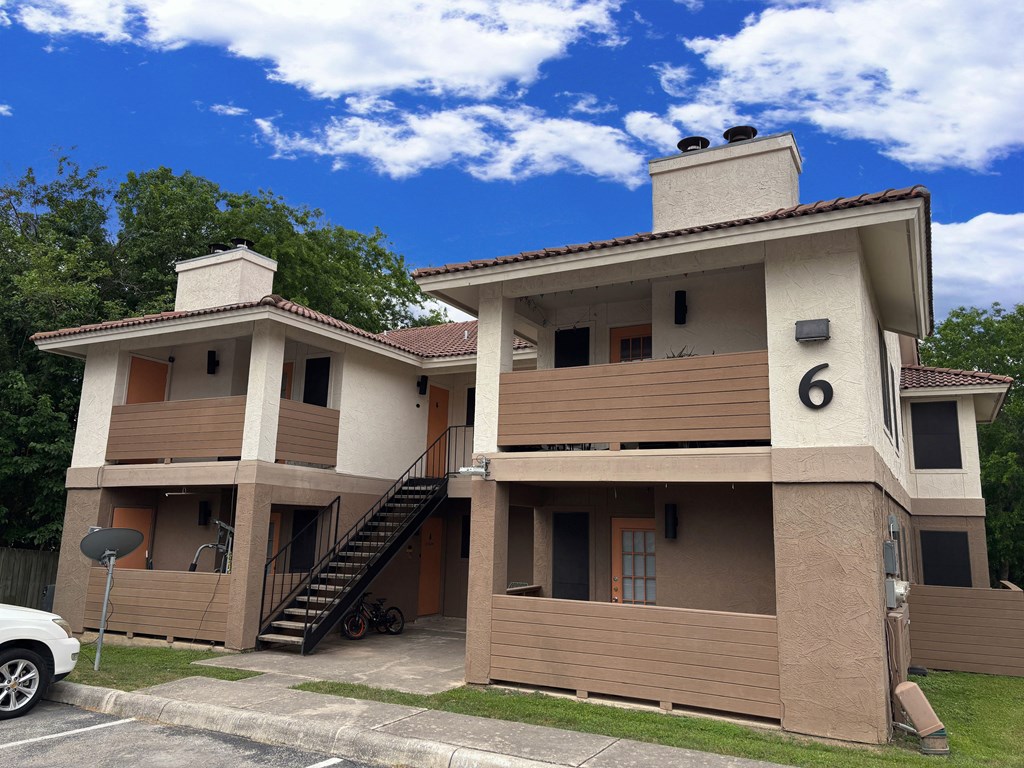 A two story house with a car parked in front.