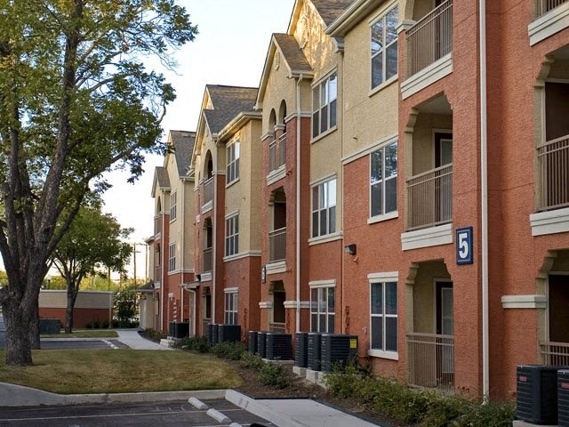a row of brick apartment buildings on a street