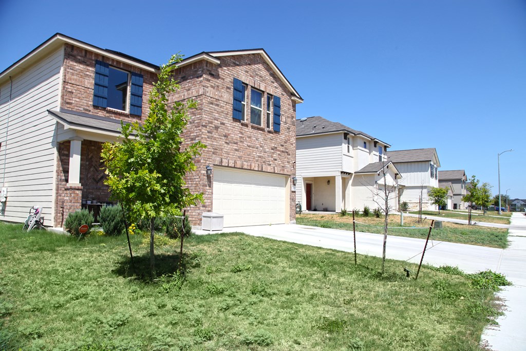 a house with a white garage door and a lawn