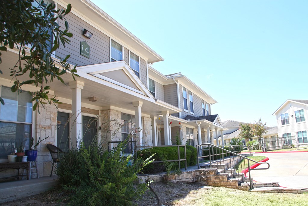 a row of houses with stairs and a red