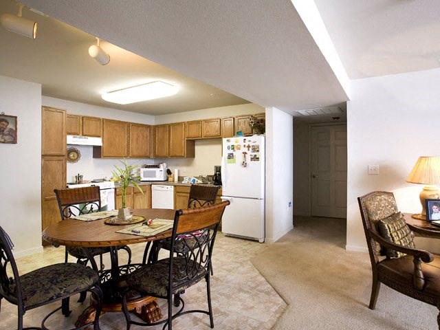 a kitchen and dining room with a table and chairs