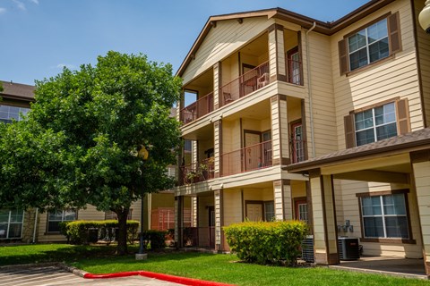 Apartment building with a red carpet in front.