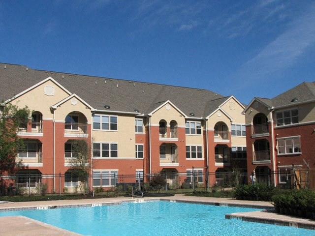 an apartment building with a large swimming pool