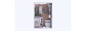 A small room with a bed, a desk, and a chair.
