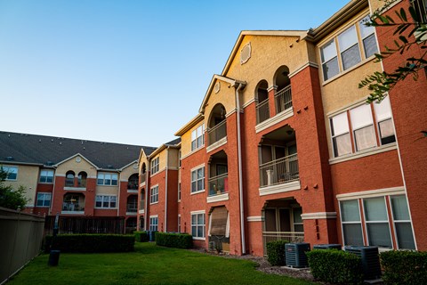 A large apartment complex with red and yellow buildings.