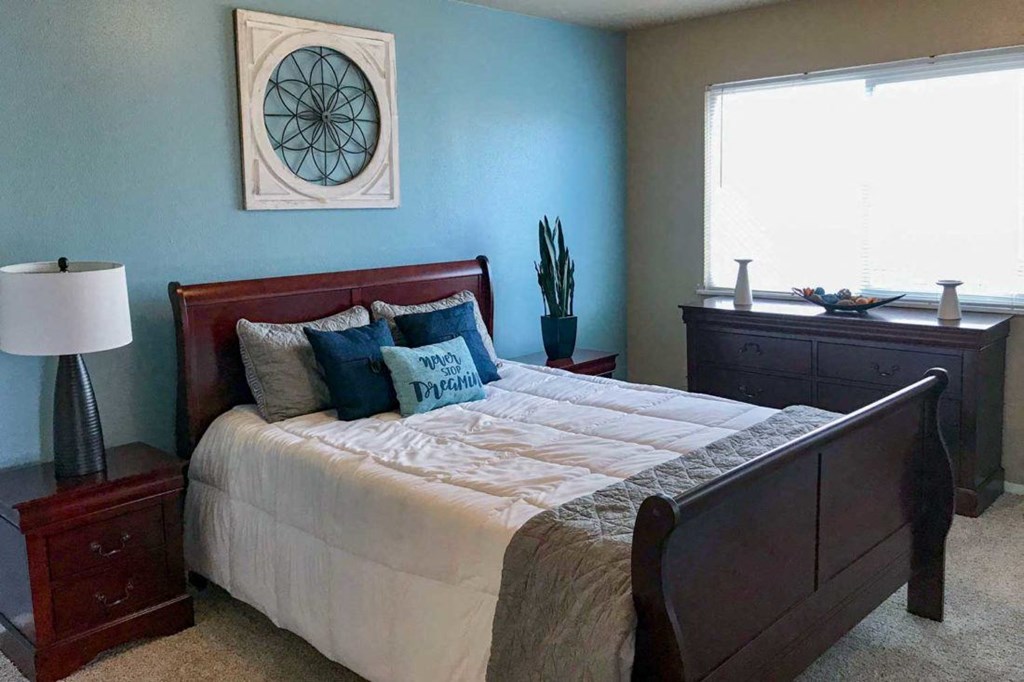 a bedroom with a bed and a window