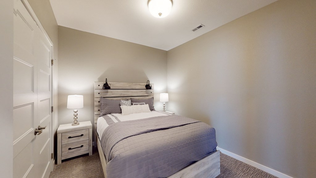 a bedroom with a bed and two night stands