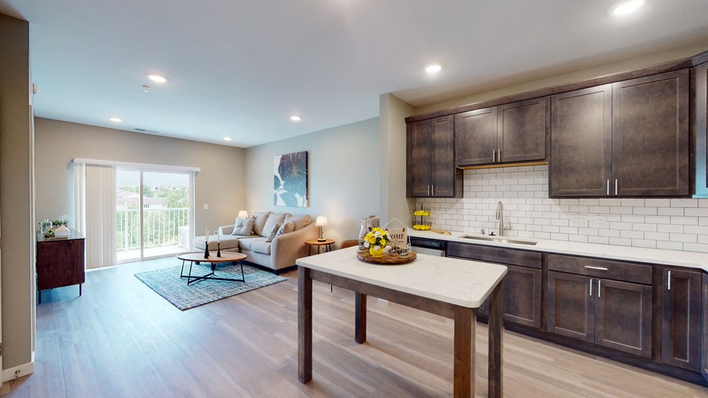 a kitchen and living room with a couch and a table