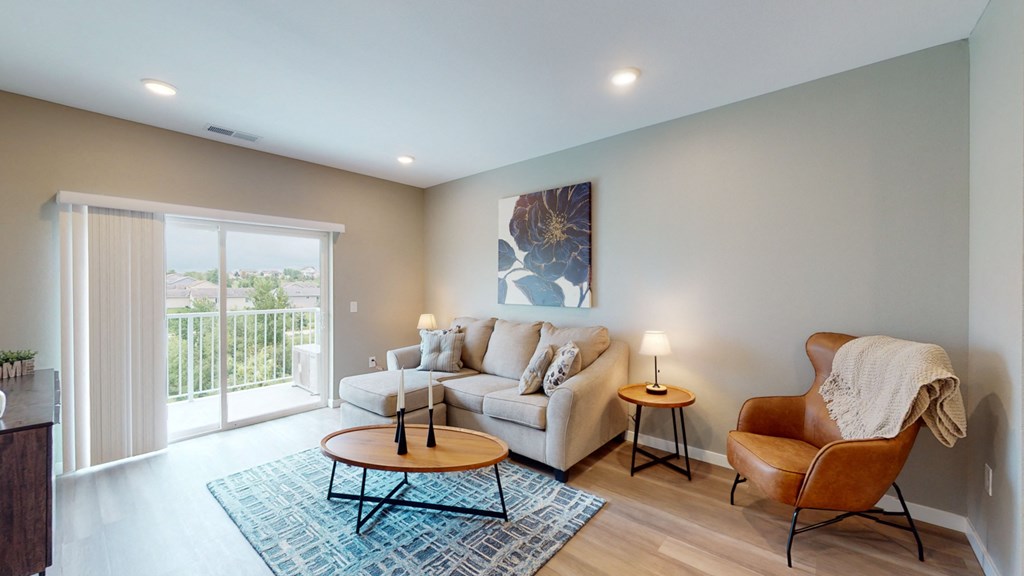a living room with a couch and a chair and a table