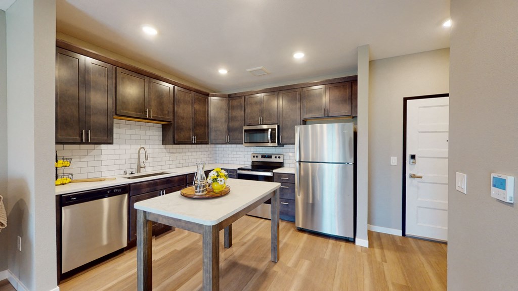 a kitchen with stainless steel appliances and wooden cabinets