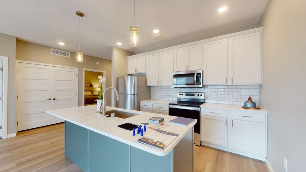 a kitchen with white cabinets and a white counter top