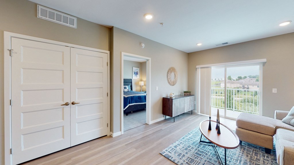 a living room with two white doors and a door to a bedroom