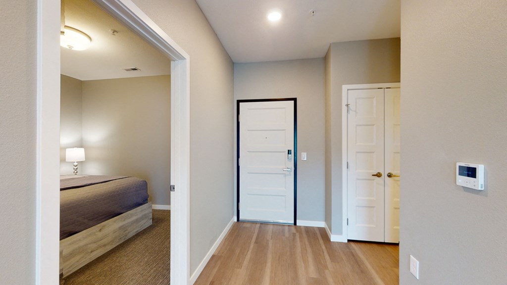 a bedroom with a bed and a closet and a door to a bathroom