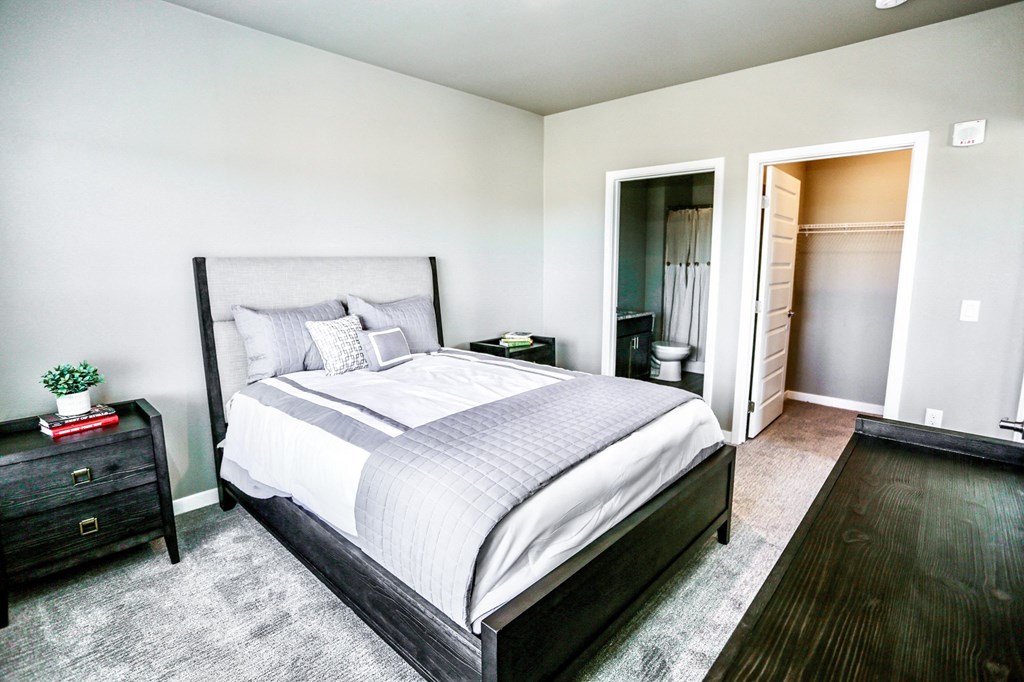 a bedroom with a bed and a closet and a bathroom