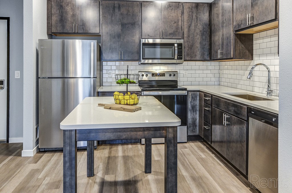 a kitchen with stainless steel appliances and wooden cabinets