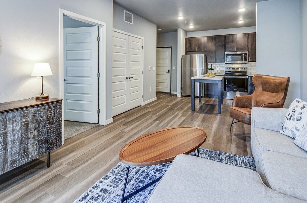 a living room with a couch and a table and a kitchen