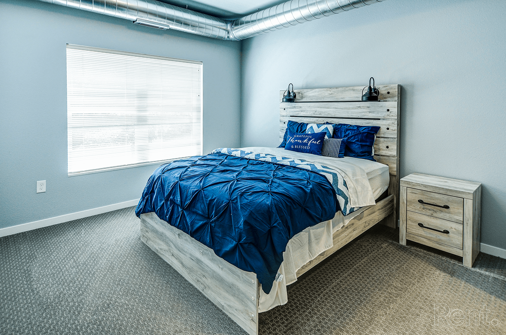 a bedroom with a bed and a window