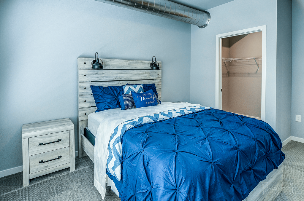 a bedroom with a bed and a closet