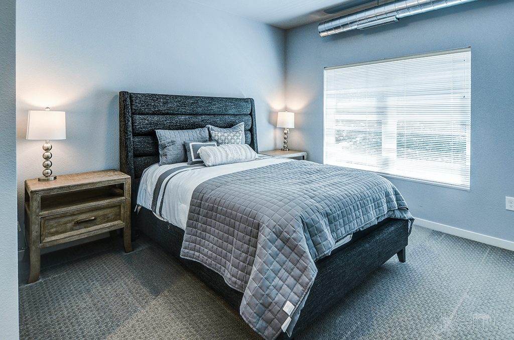 a bedroom with a bed and a window