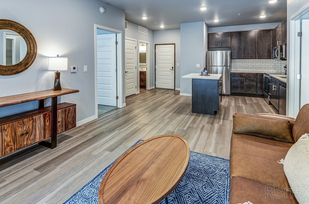 a living room with a couch and a table and a kitchen