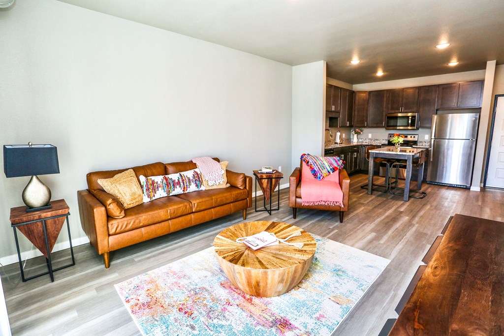 a living room with a couch and a table and a kitchen