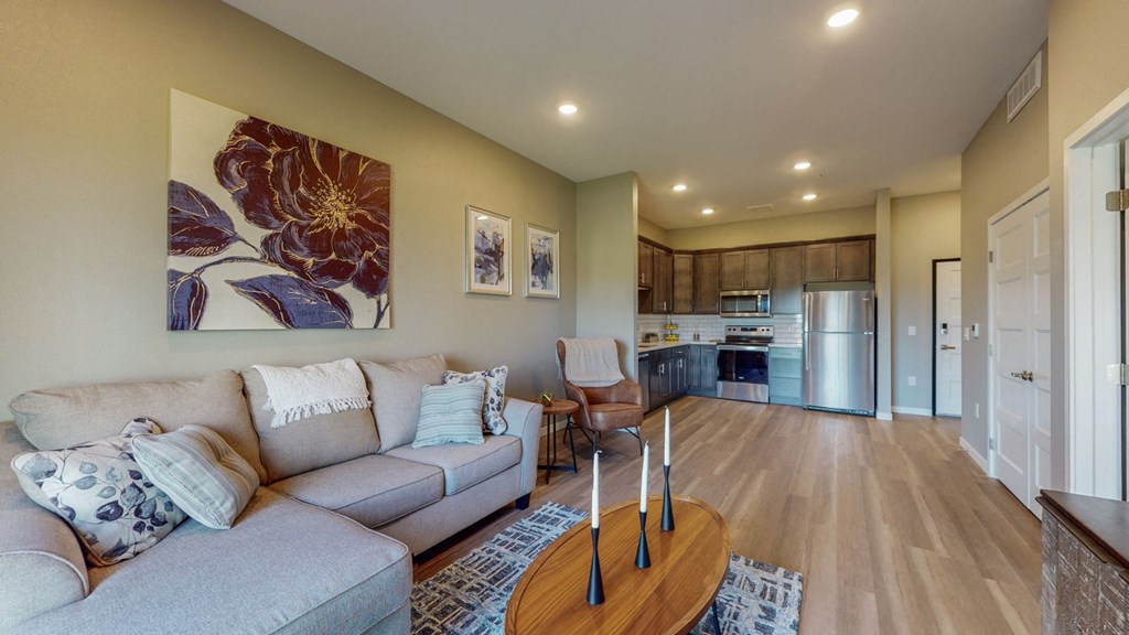 a living room with a couch and a kitchen