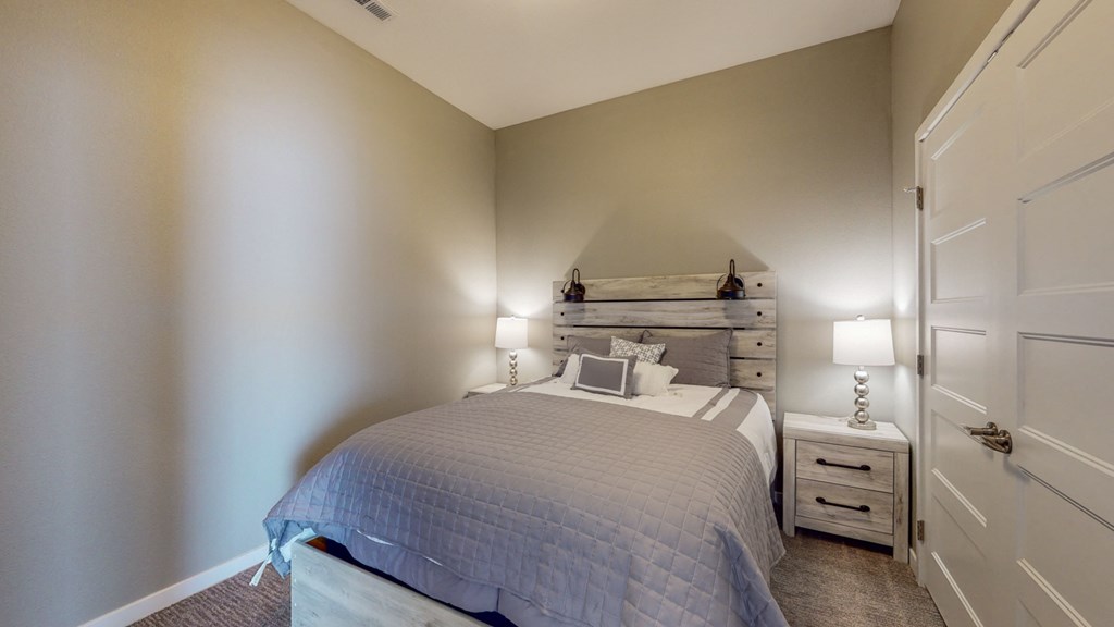 a bedroom with a bed and a dresser and a window