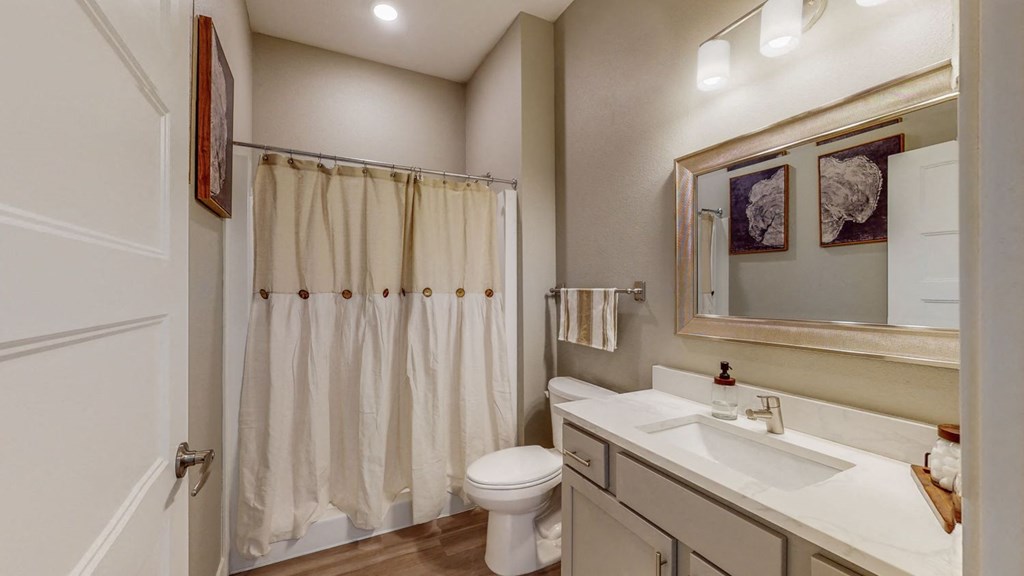 a bathroom with a shower and a sink and a toilet