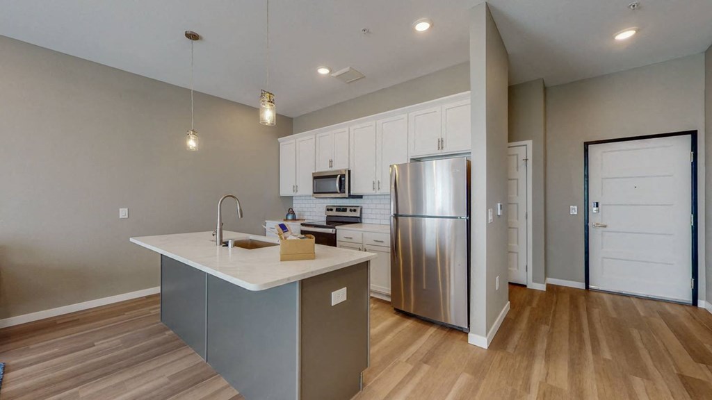 a kitchen with stainless steel appliances and a counter top