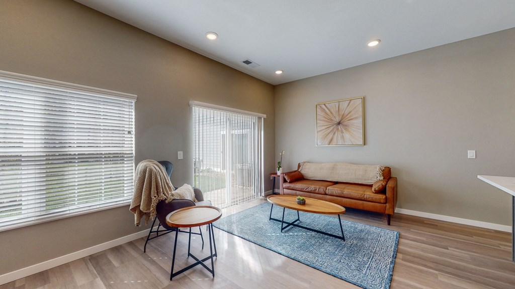 a living room with a couch and a chair and a table