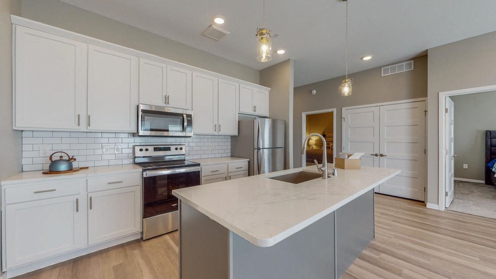 a kitchen with white cabinets and a counter top