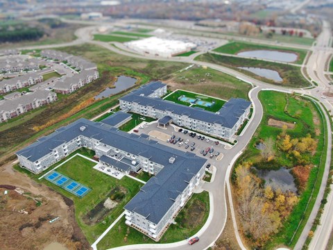 A large building with a pool in front of it.
