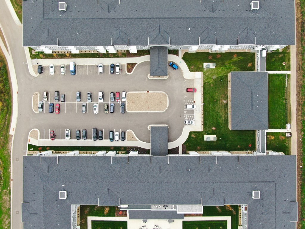 an aerial view of a parking lot with cars parked