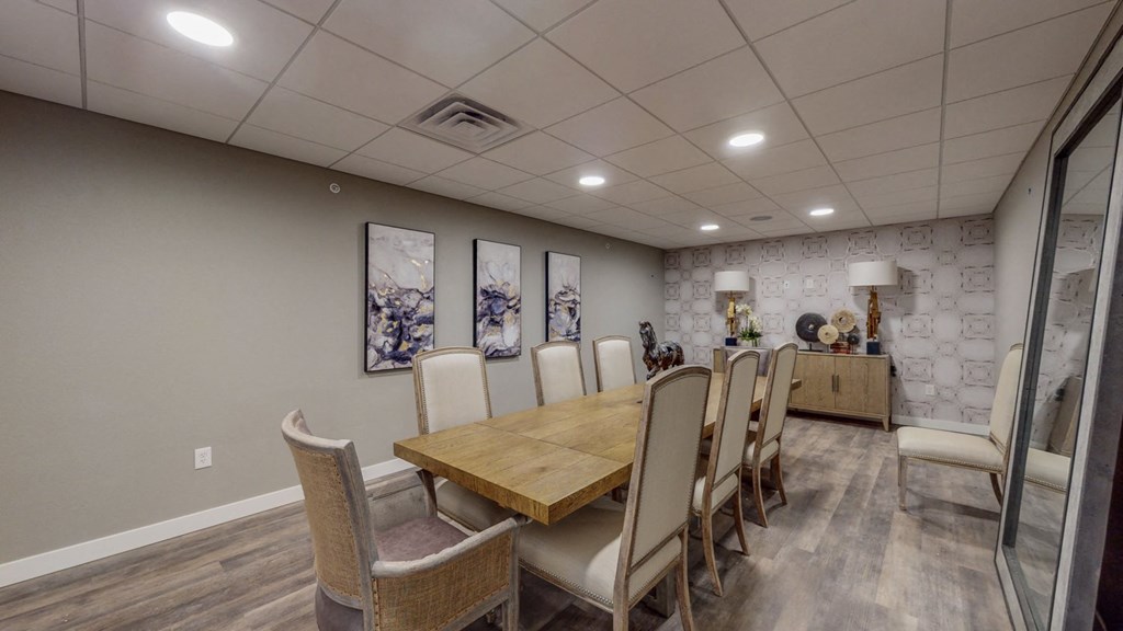 a dining room with a wooden table and chairs