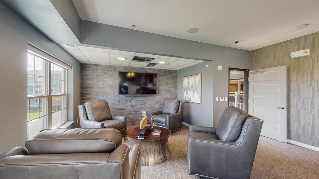 a living room with couches and chairs and a television