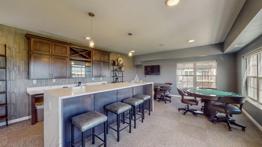 a game room with a bar and a pool table