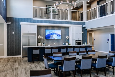A modern dining room with a large table and chairs.