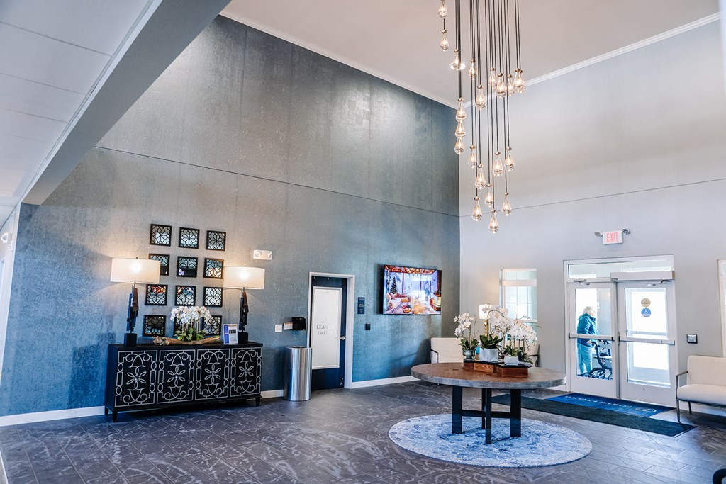 a lobby with a table and a chandelier