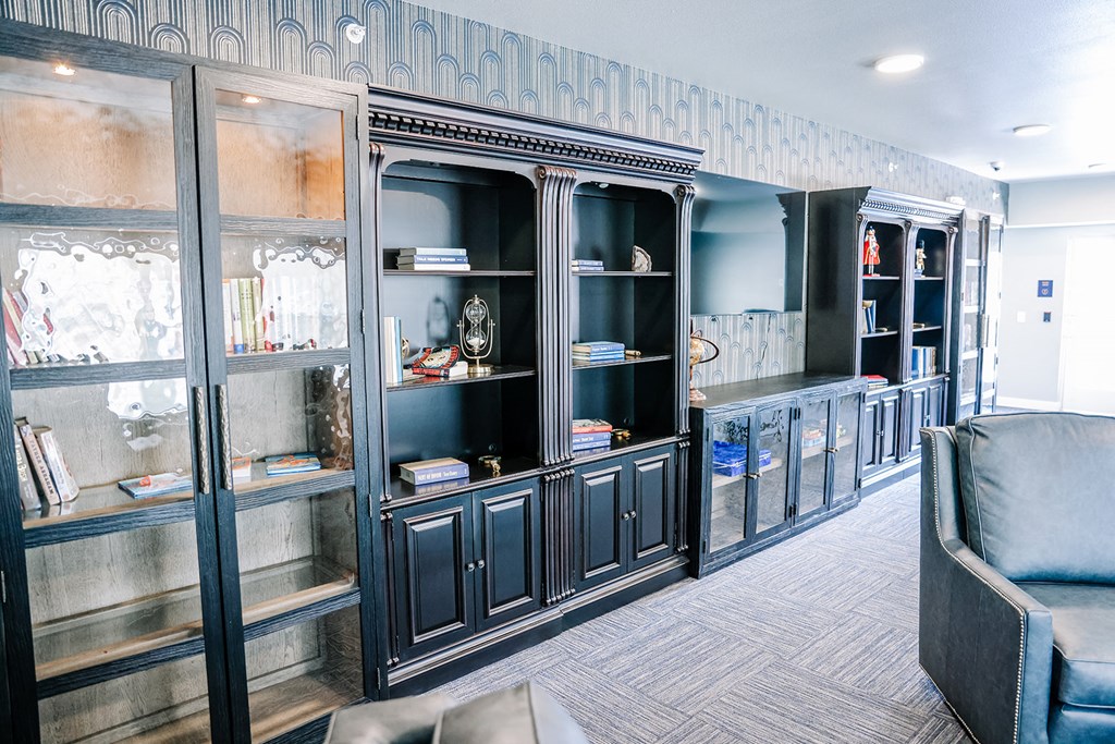 a living room with glass cabinets and a couch