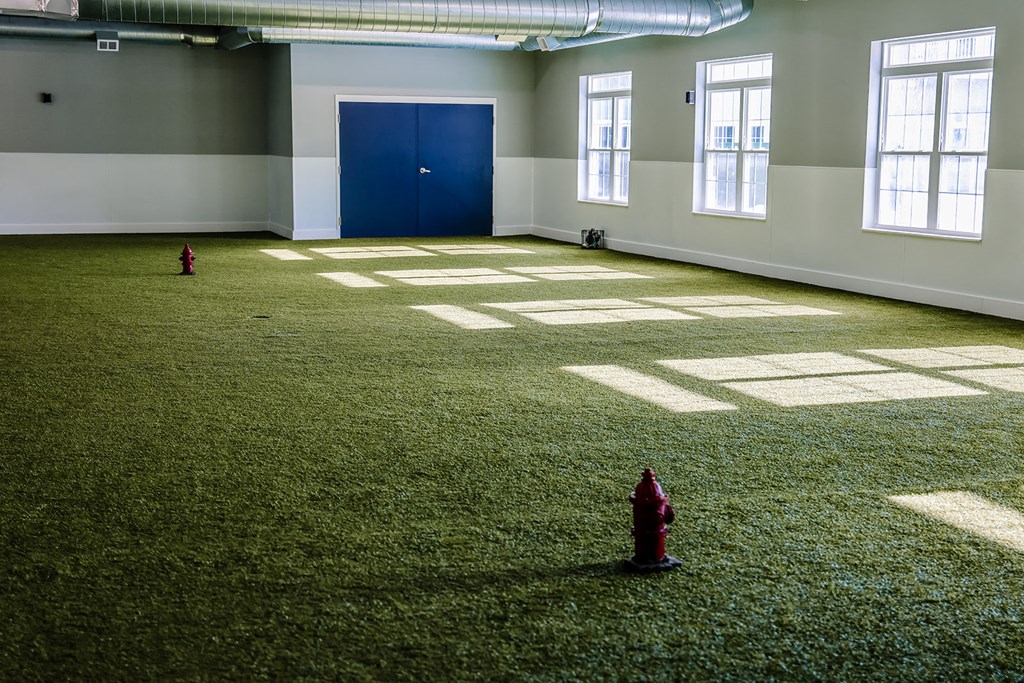 an empty room with two red fire hydrants in it