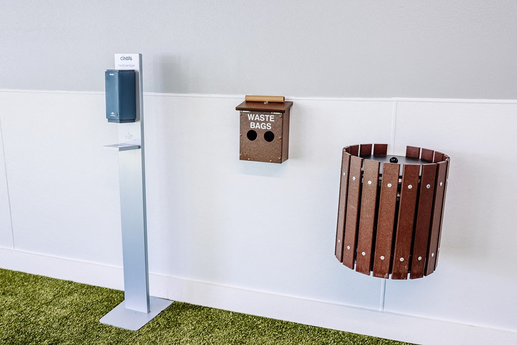 a wall with a trash can and a waste basket on the wall