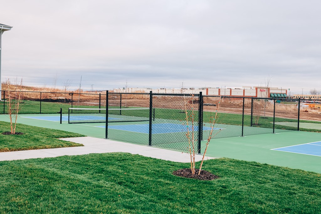 a tennis court with a chain link fence around it and a tennis