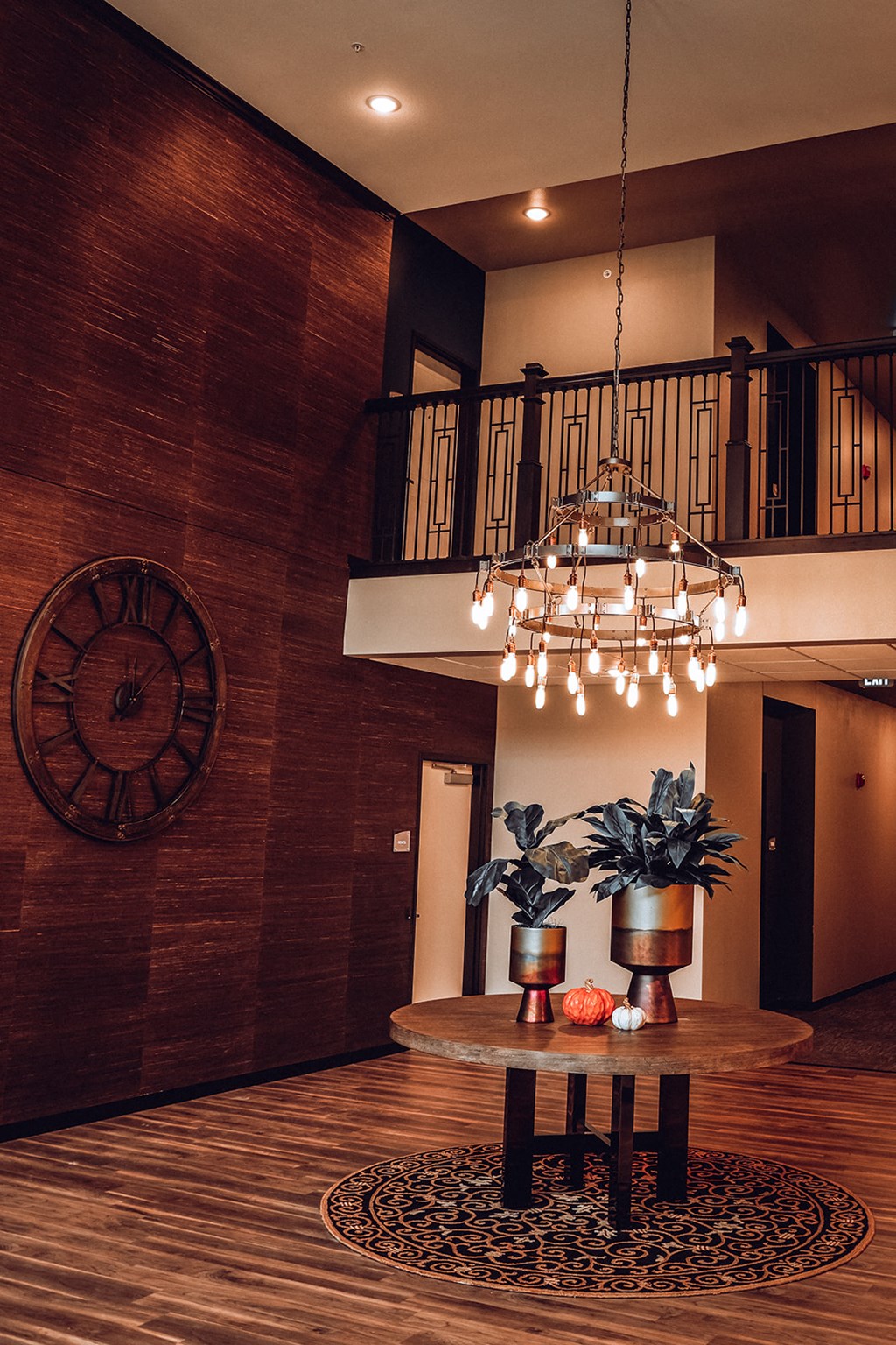 a living room with a table and a chandelier