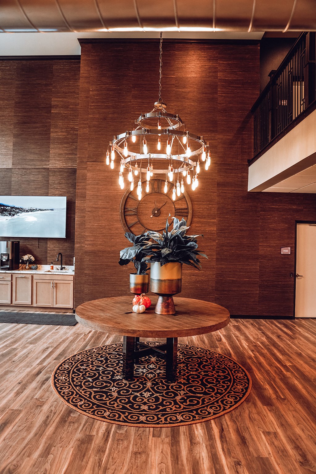a living room with a table and a chandelier