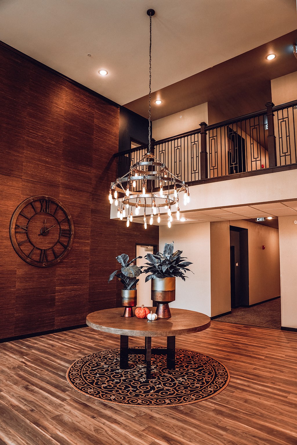 a lobby with a chandelier and a large clock on the wall
