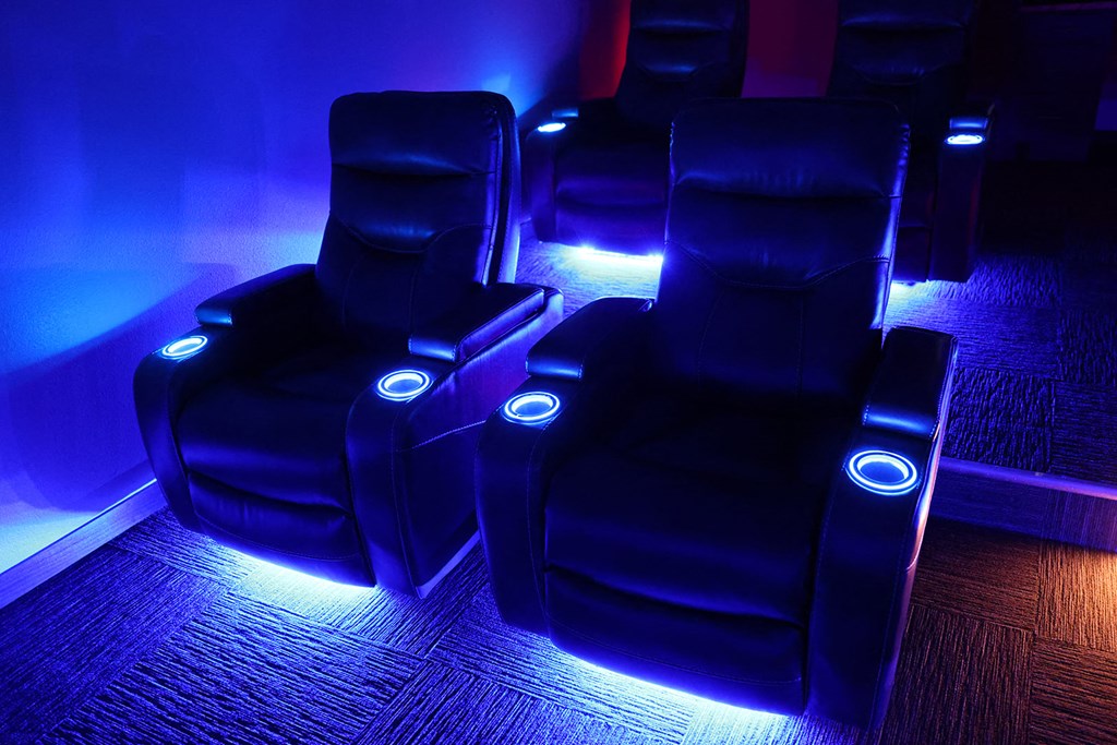 the lounge chairs are lit up with blue lights
