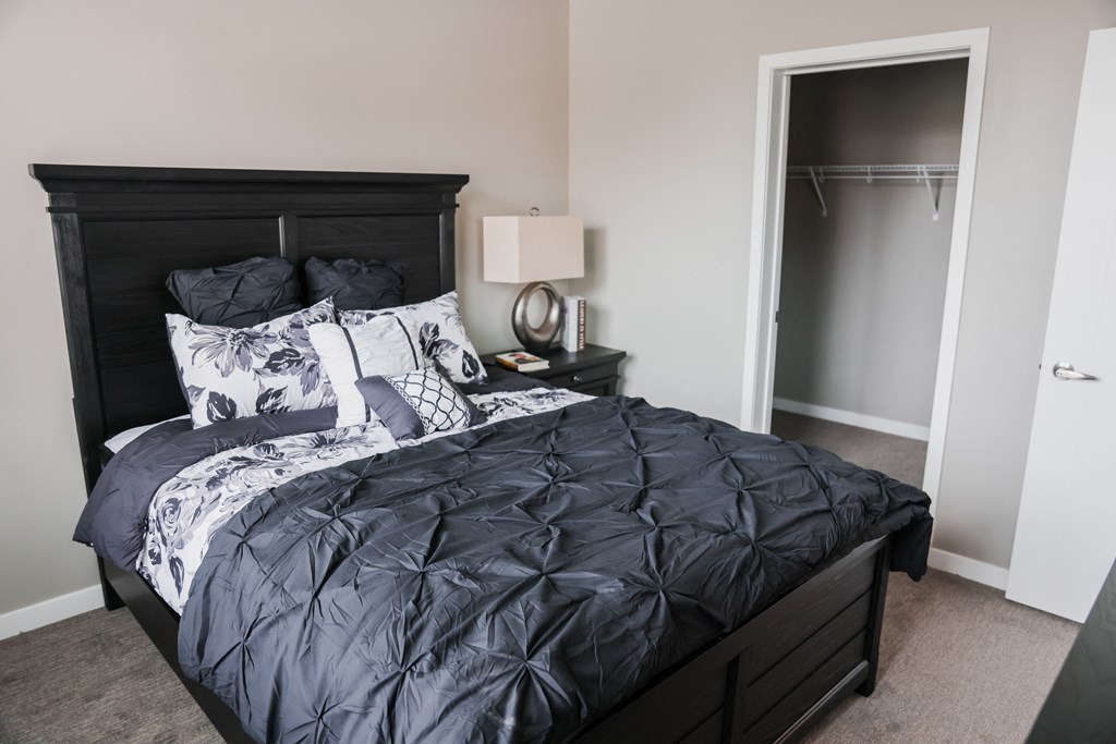 a bedroom with a large bed and a closet