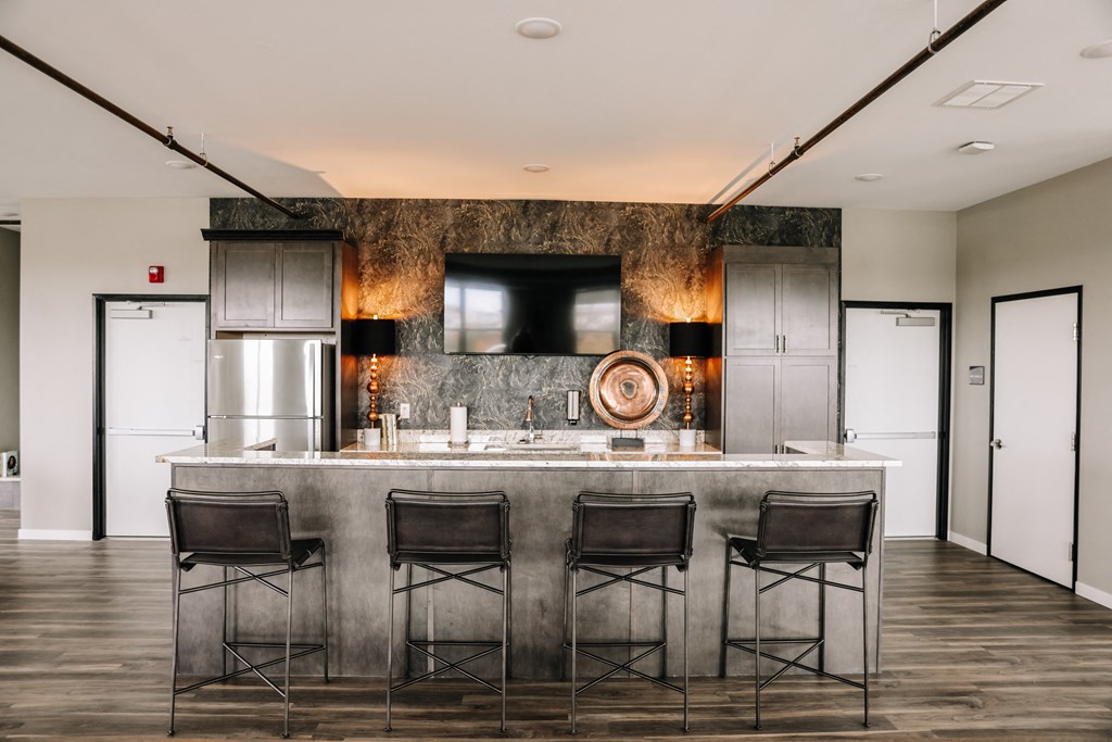 a kitchen with a marble counter top and bar stools