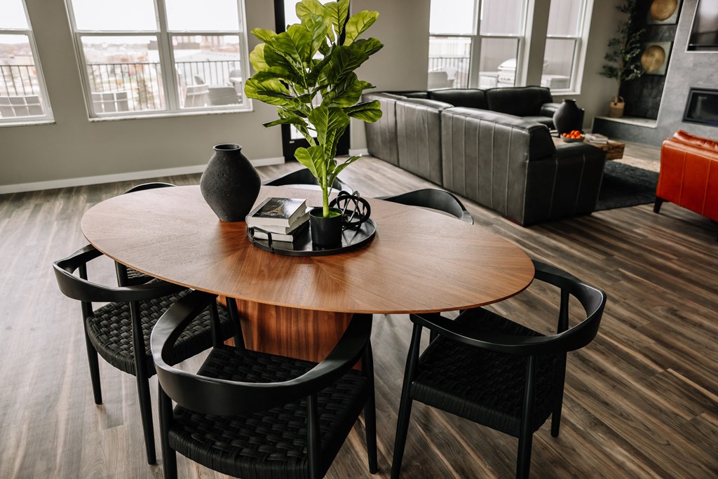 a dining room with a wooden table and black chairs